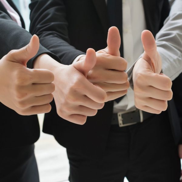 Group of business people showing thumb up gesture